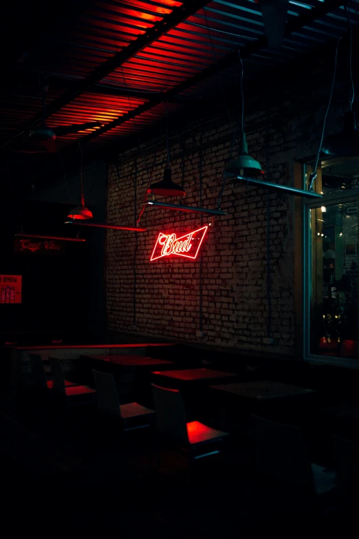 the restaurant has red neon lights and red sign