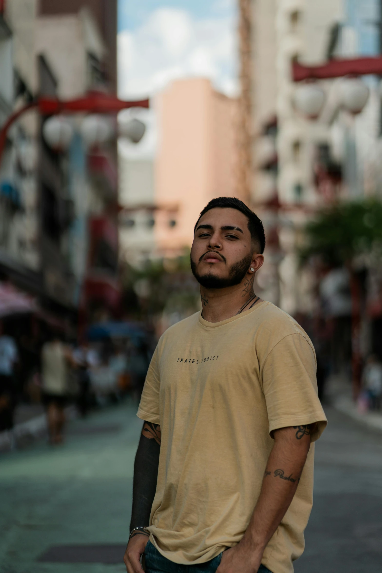 a man standing on the sidewalk with a city in the background