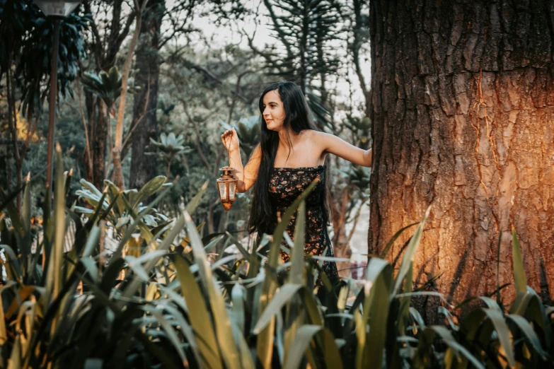 a woman in the woods is holding a bird