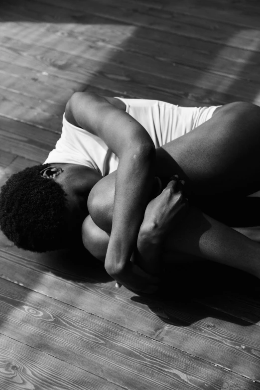 a man laying on his back while holding his hand up to his chest