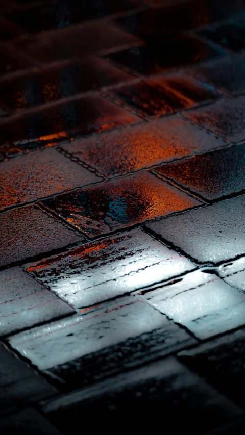 rain is covering the tiles on the sidewalk