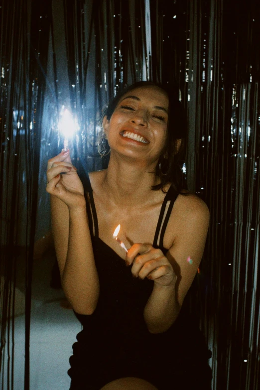 a woman sitting down with her candle in her hands