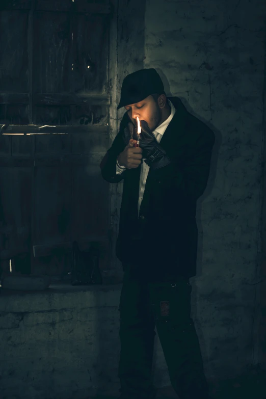 a young man in a dark suit holding a lit cigarette