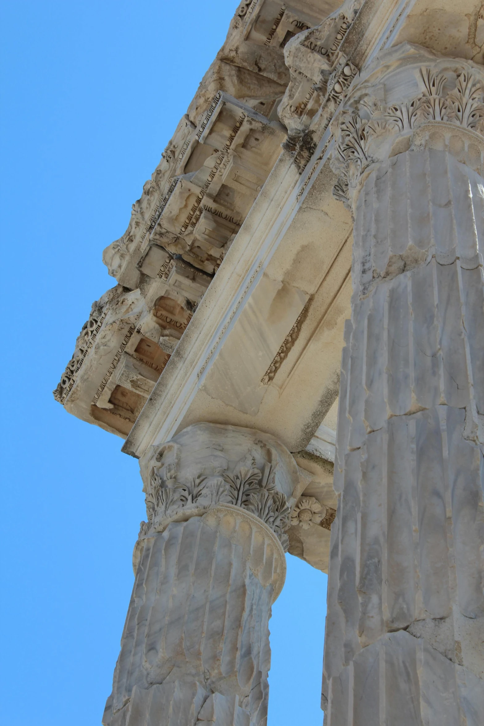 the side of an old roman temple with several carved columns