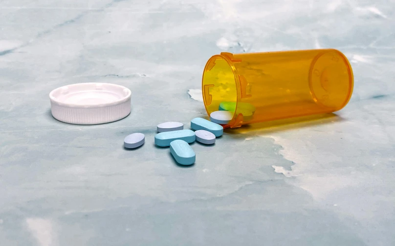 an open orange pill bottle on top of a table