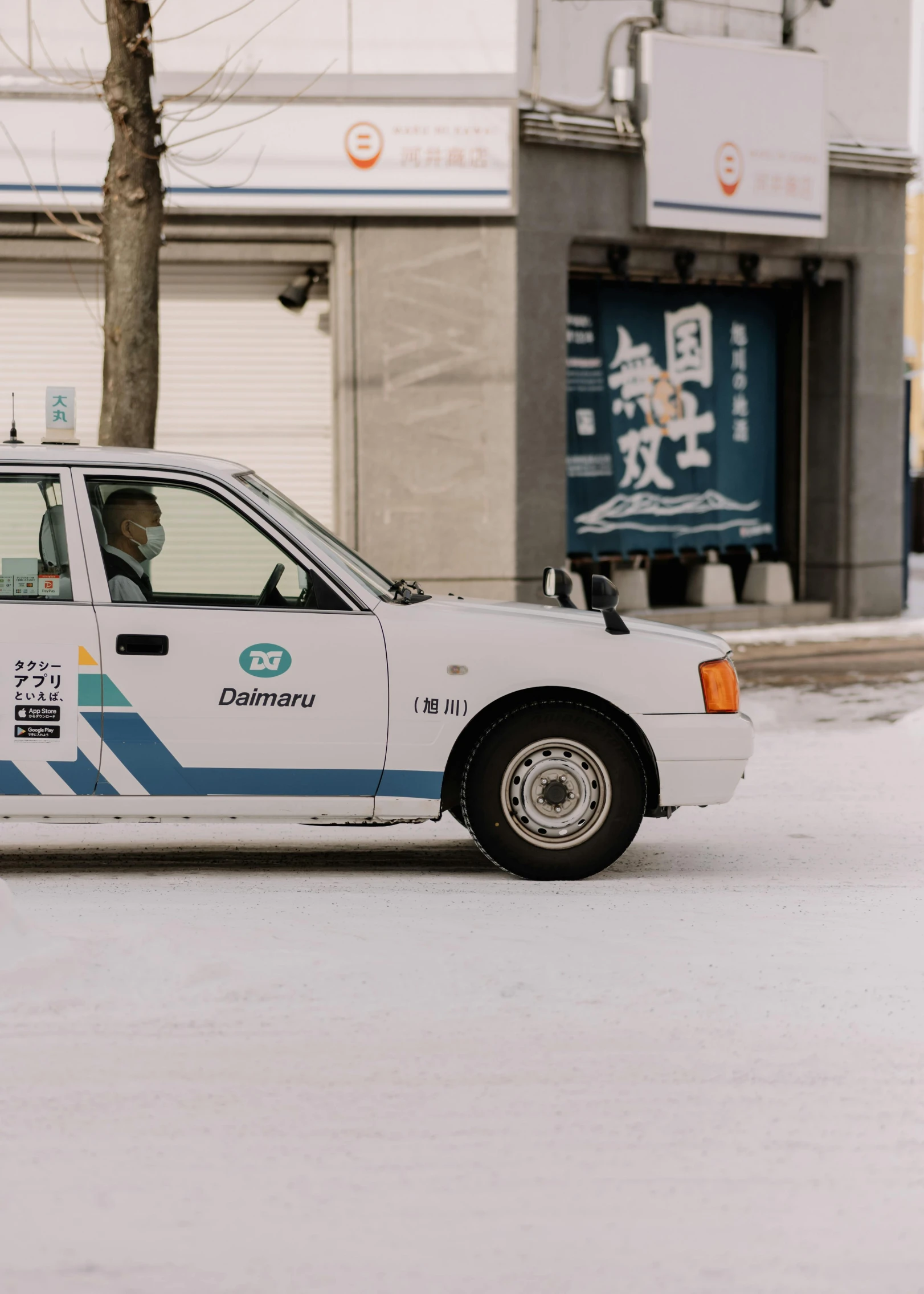 a taxi cab sitting next to a street filled with snow