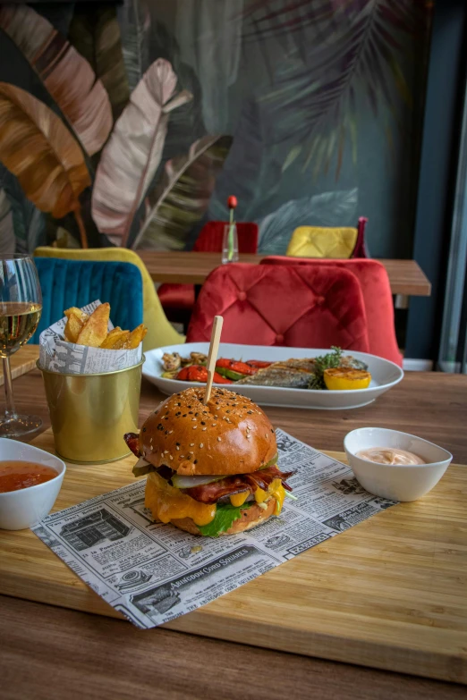 a table with a dog and some fries and dipping sauces