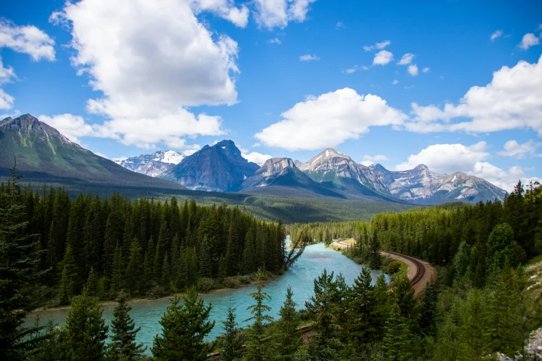 there are several mountains in the distance with a river running through it