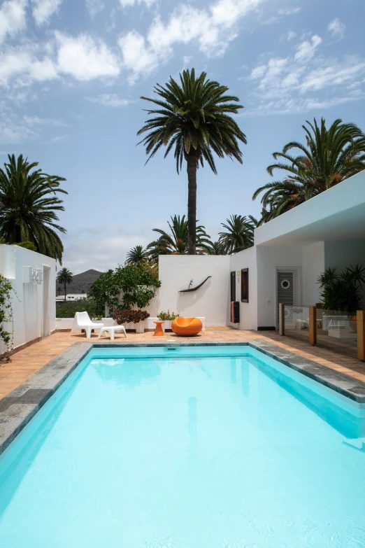 a small pool with chairs surrounding it