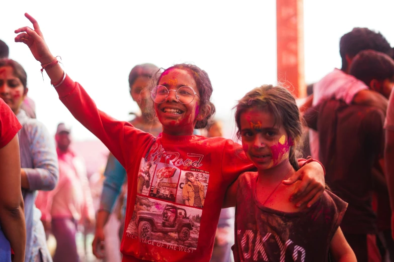 two s standing in front of a crowd of people