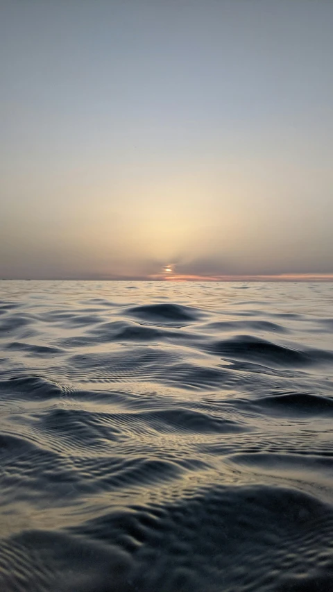 a body of water with a sky in the background