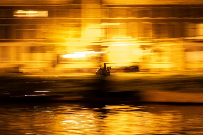 a large boat traveling down a river in front of a building