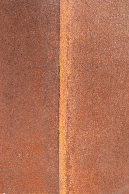 the left side of an orange and black concrete building