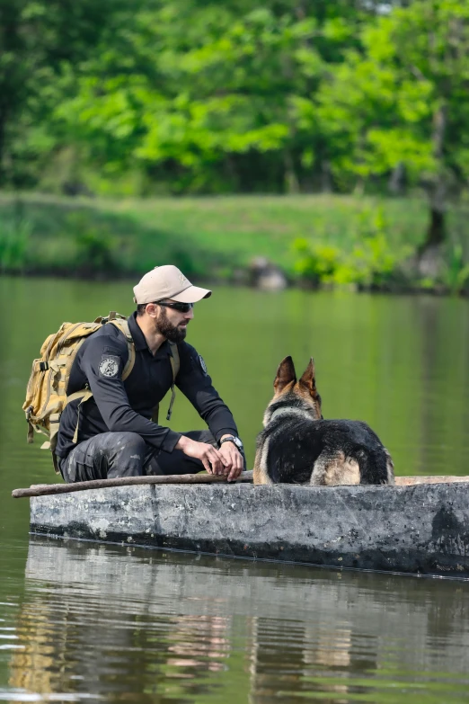 a man and a dog are in a canoe