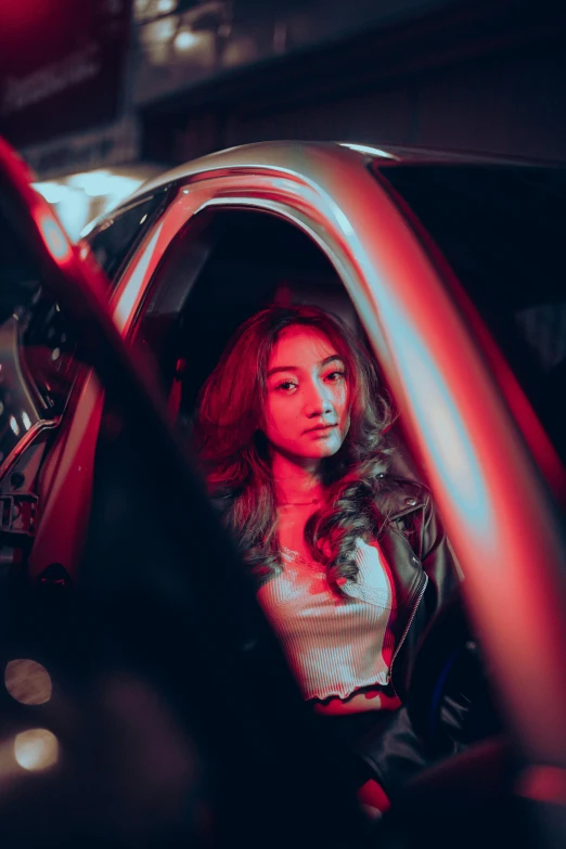 a woman sitting in a car with an umbrella in it