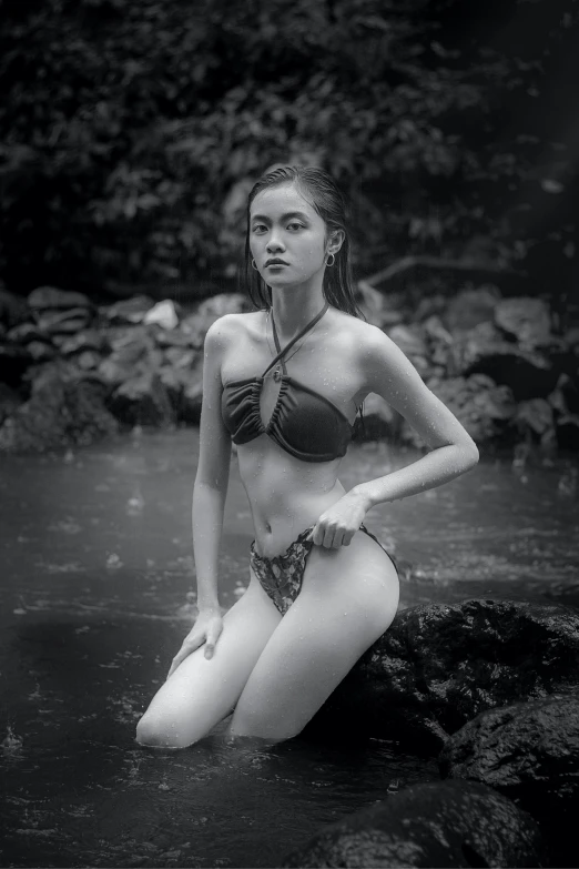 a woman standing in the water wearing a bikini