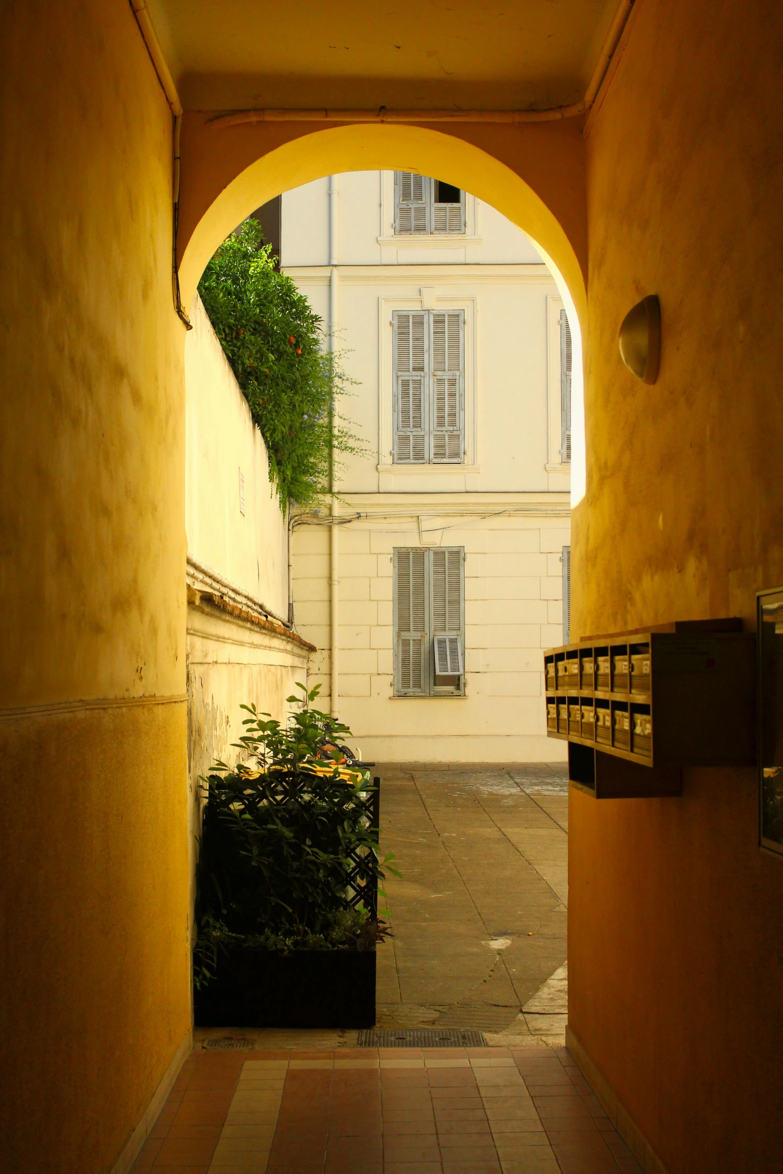 a very narrow, alley way that leads up to a building