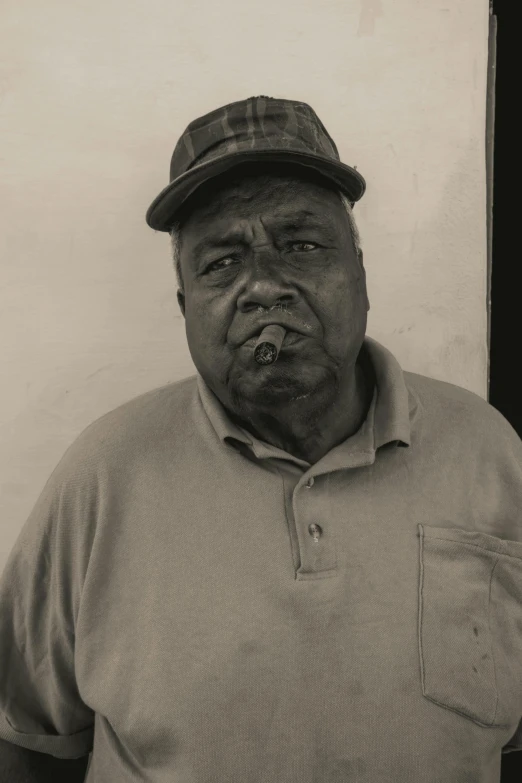 an old man wearing a hat standing with his hands on his hips