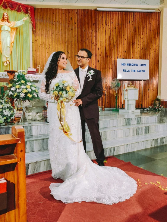 the newly married couple are standing in front of a alter