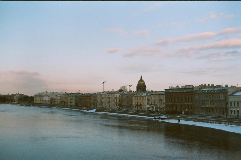 a river and buildings in the city on a winter day