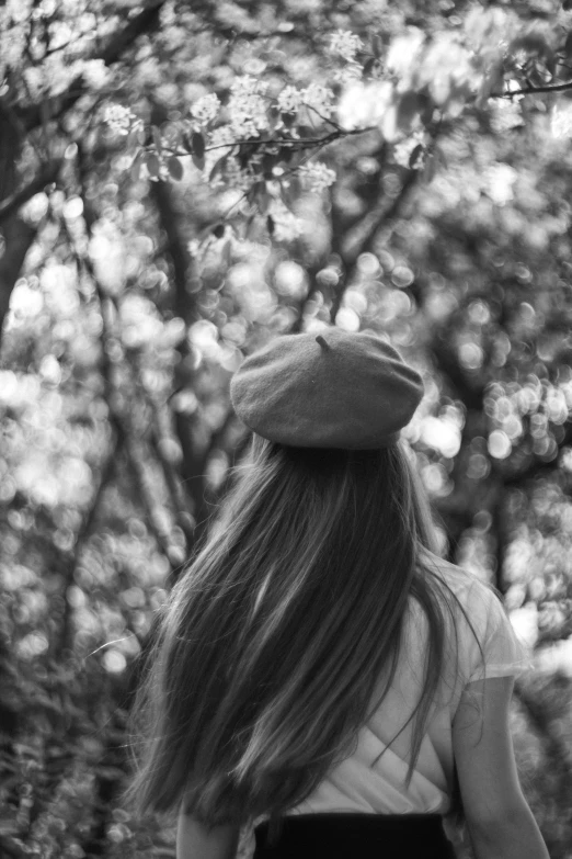 a woman walks through the woods with long hair