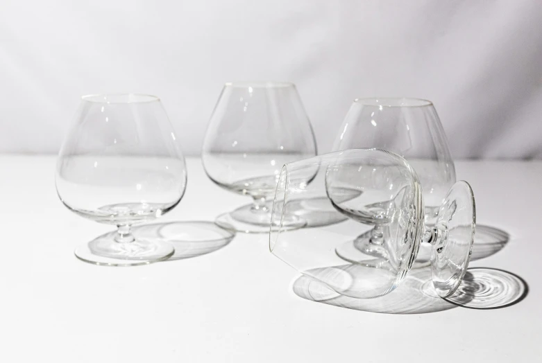 a line of empty wine glasses on top of a table