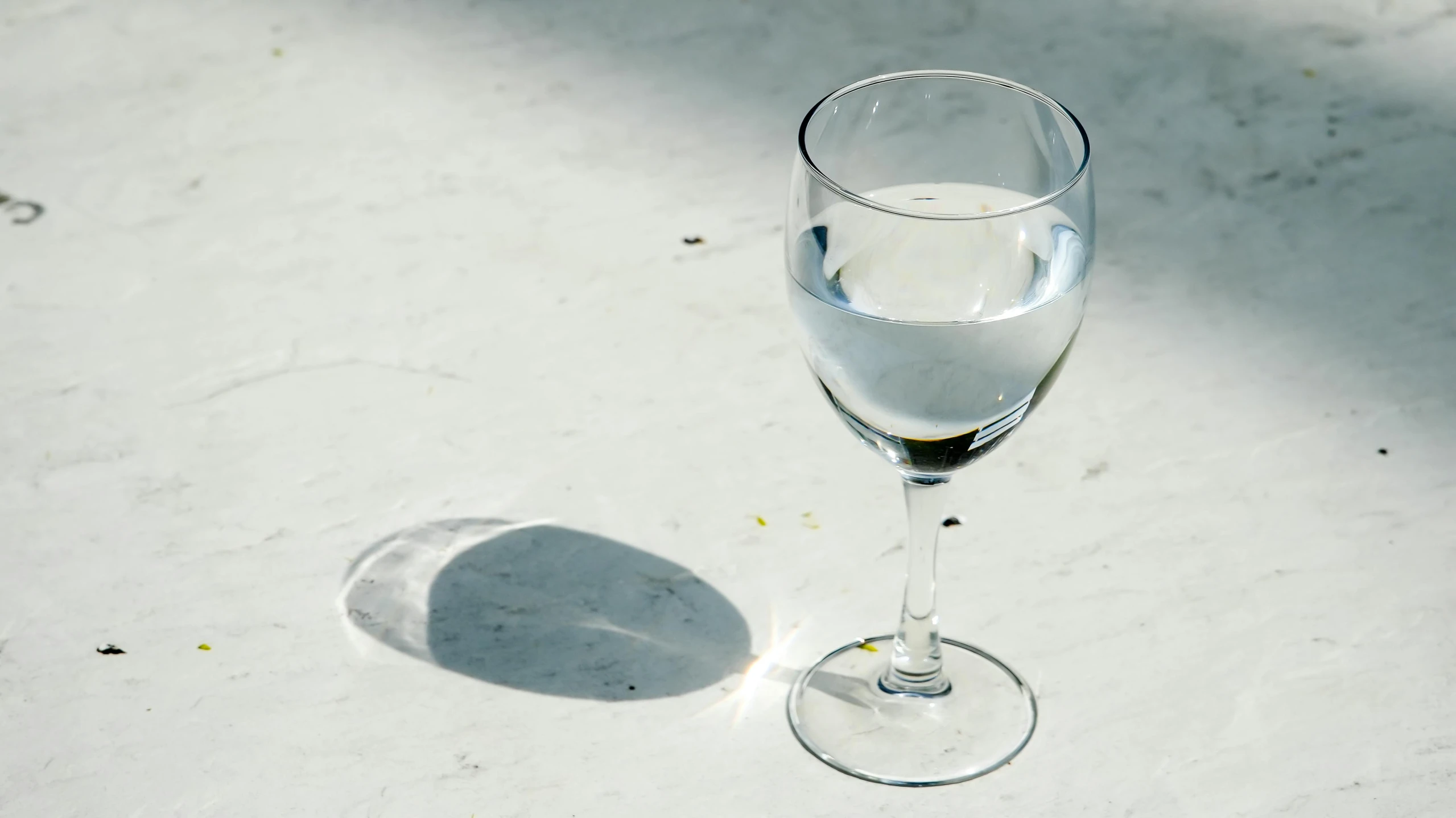 a wine glass on a white table top