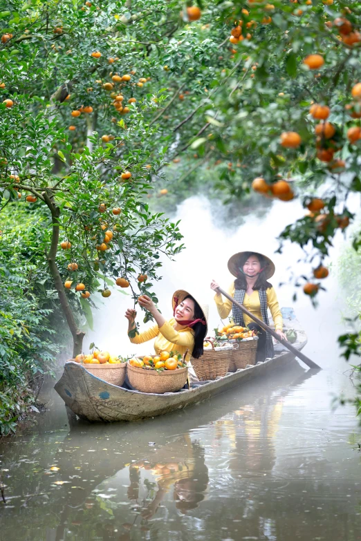 two women in a boat filled with fruit