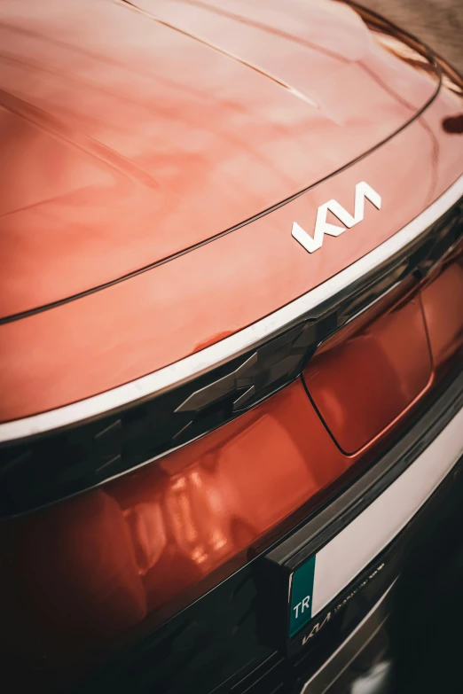 a close - up of the front of an orange, modern sports car