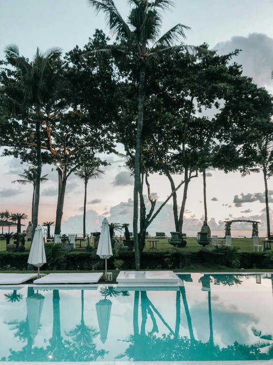 the sun is rising over an empty swimming pool