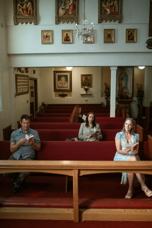 several people sitting on pews in a church