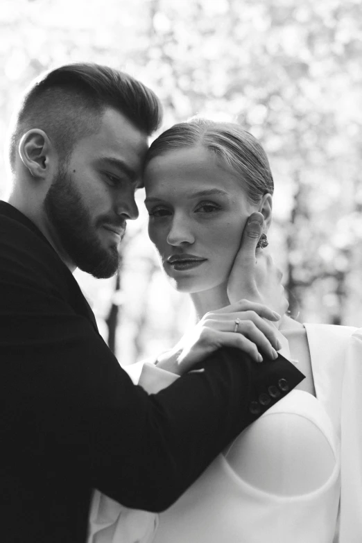 man and woman emcing each other while they stand outside