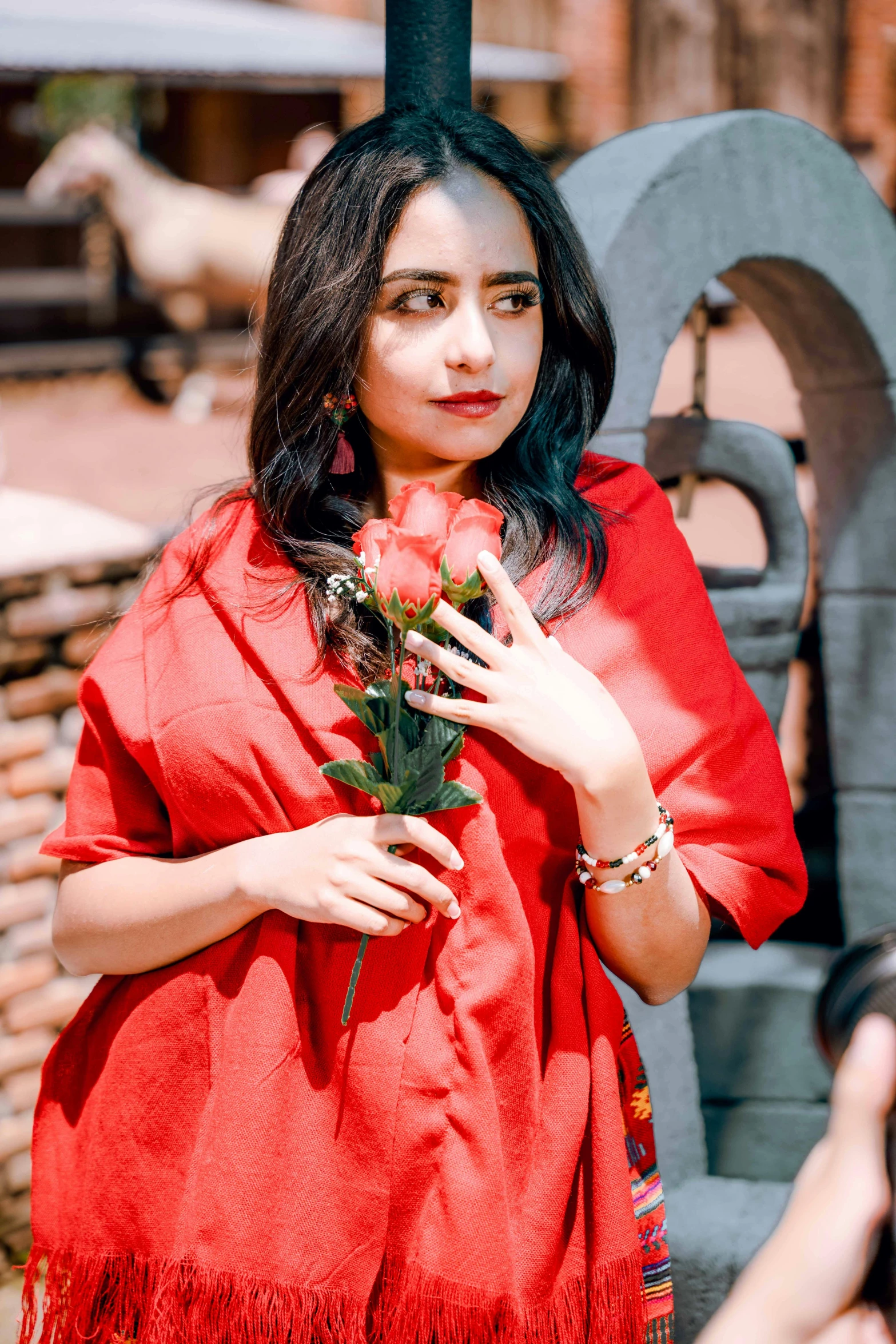 a woman holding flowers posing for the camera