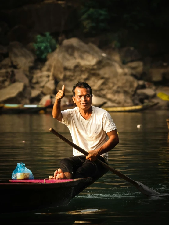 a man paddles in a boat on a river