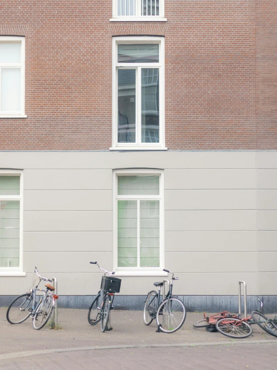 bikes are parked in front of a large brick building