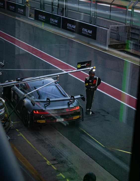 the car has stopped on the track with its roof raised