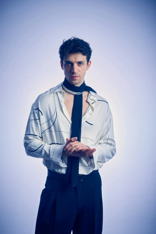 a man wearing a necktie poses in a white shirt