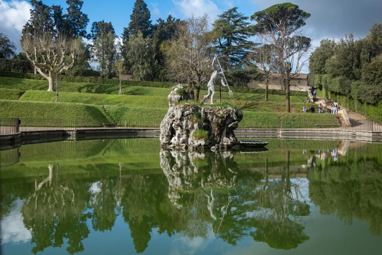 a pond in a park filled with trees