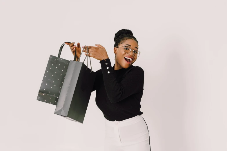 woman in glasses holding a purse and smiling