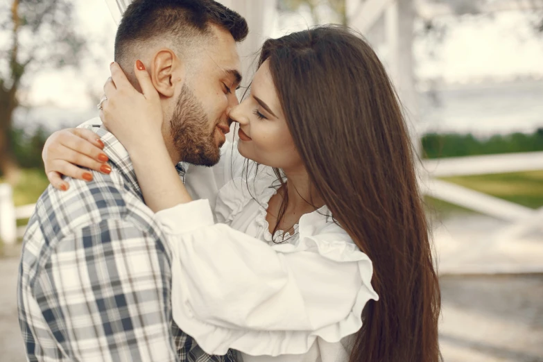 a man and woman kiss while the woman holds her head to the side