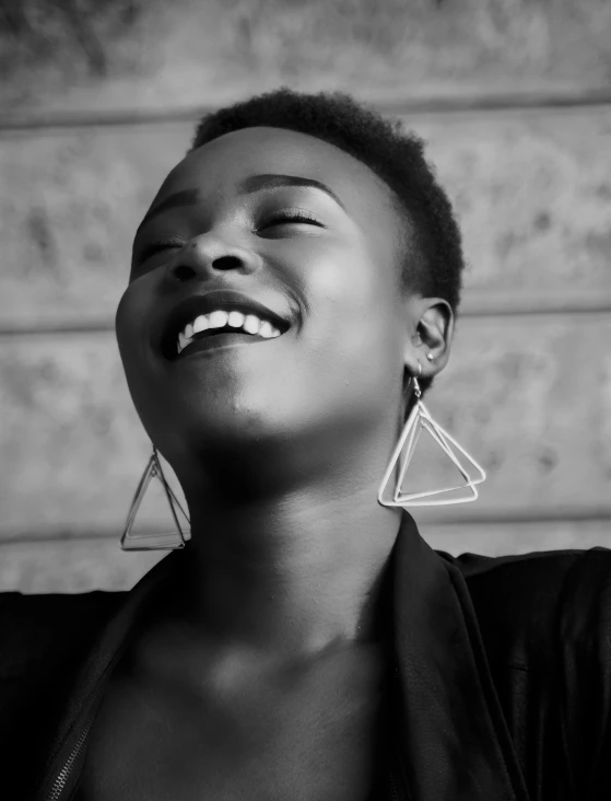 black and white po of a woman wearing earrings