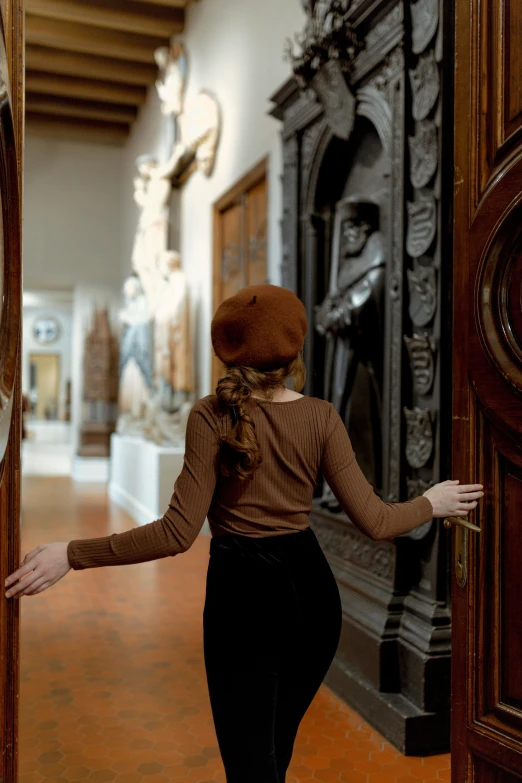 a woman is walking through an ornate hallway