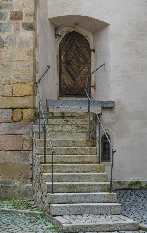 a set of steps leading up to a wooden door