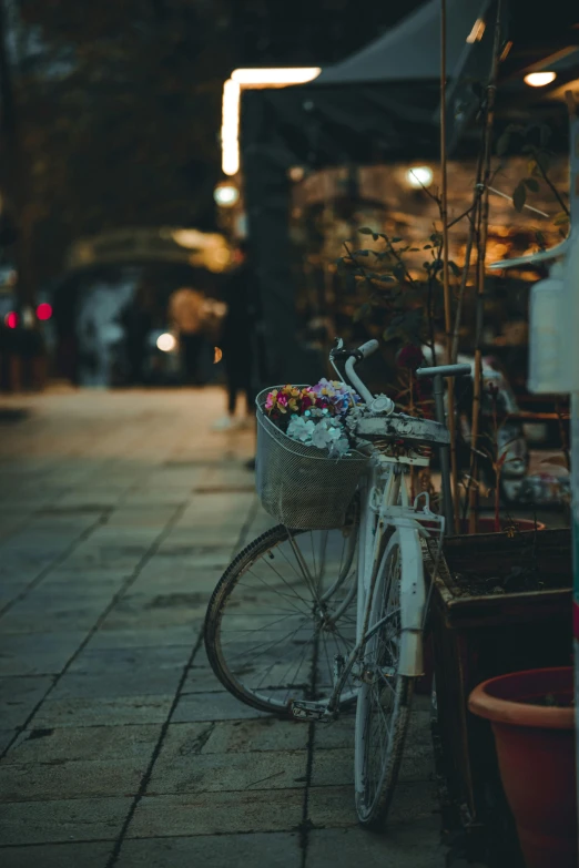 a bike leaning against the wall on the sidewalk