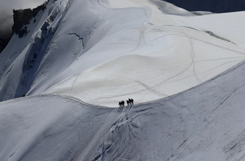 three people are skiing on a ski slope