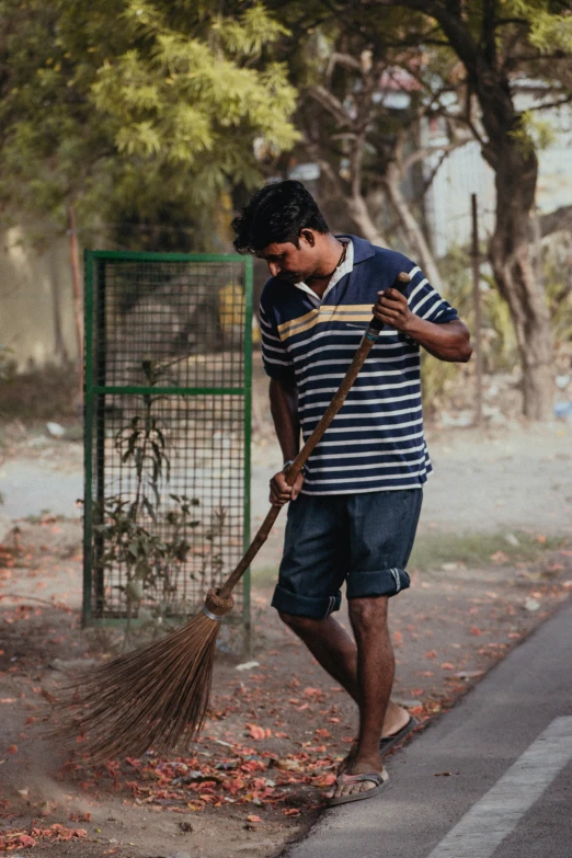 a man with a broom is cleaning the street