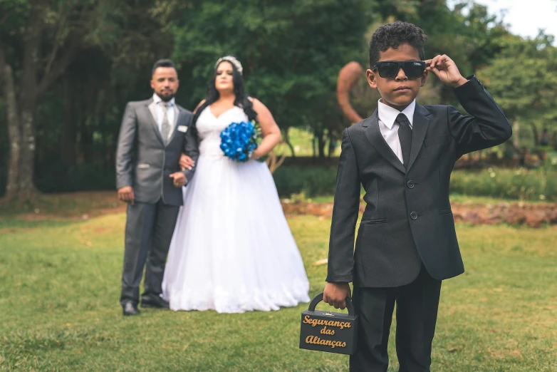 a wedding couple dressed up, one of them carrying a briefcase