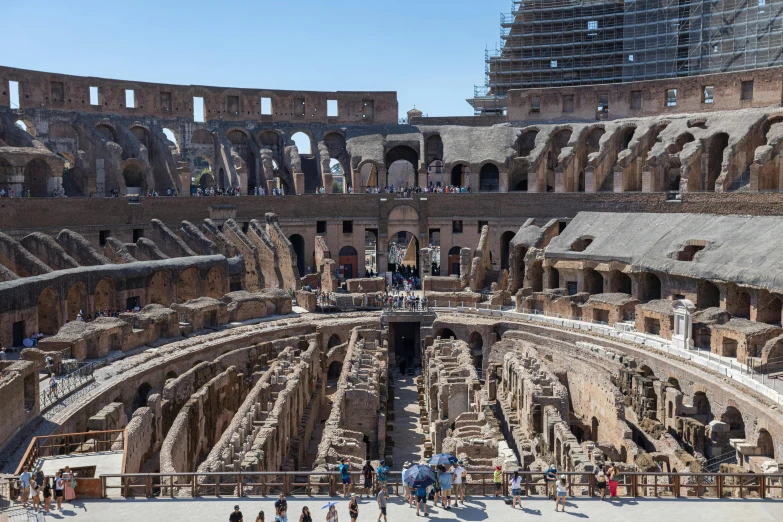 many people in a massive building that is made of stone