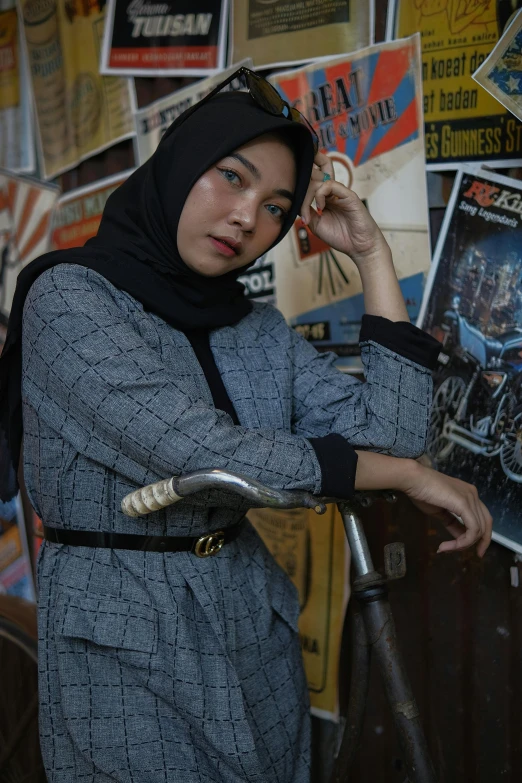 a woman holding a hand pole with a bike in front of her