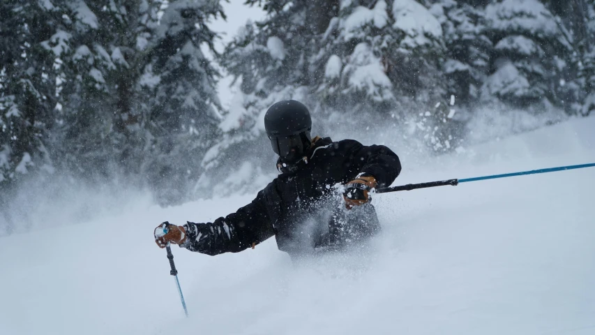 a skier is taking off down the mountain in the snow